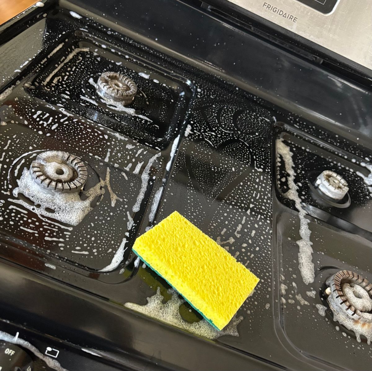 True Care Cleaning at work — a sudsy stovetop being cleaned